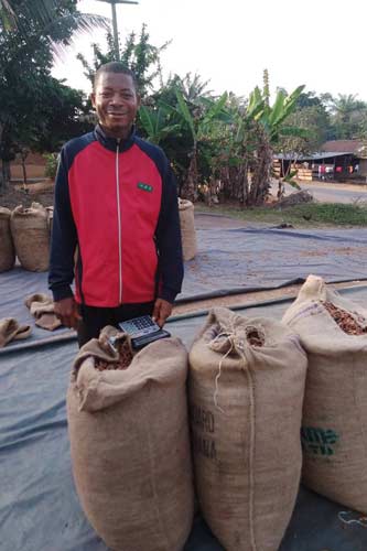 Akpere Ejah Frances, a cocoa trader in Bankpor community in Cross River state. He purchases fresh beans from farmers, dries them and sells to other traders and small processors.