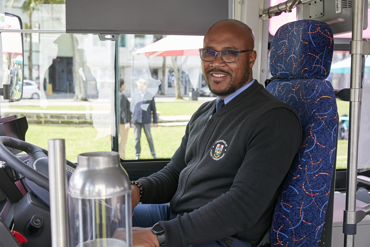 EV bus driver greeting passengers