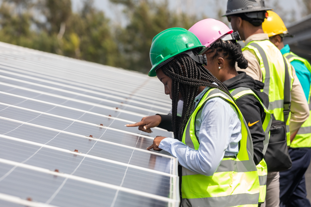 Fellows at the airport solar project, a 19-acre site with 24,000 panels.
