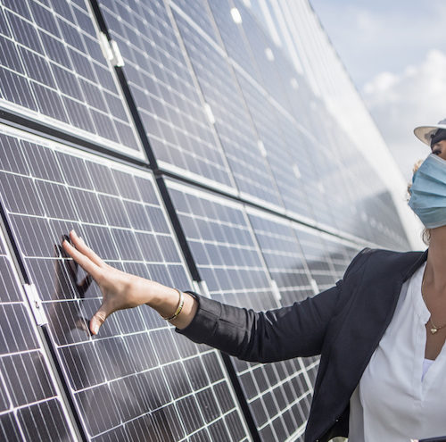 female manager beside solar panel