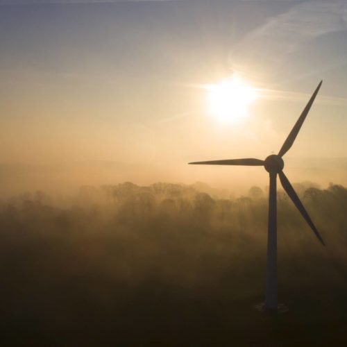 Wind turbine in sunny fog