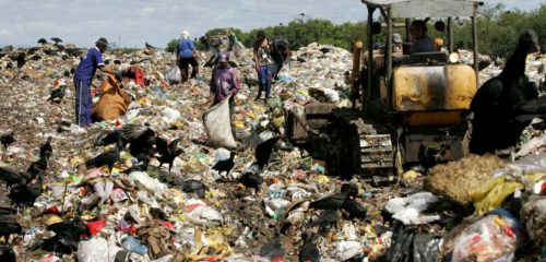 people trawl through landfill