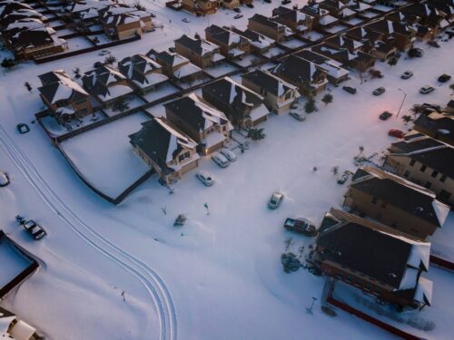 aerial view of snow covered suburban houses