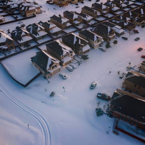 aerial view of snow covered suburban houses