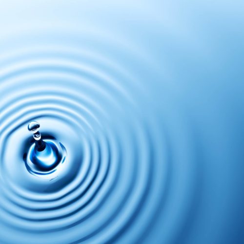 water droplet hitting water causing ripples
