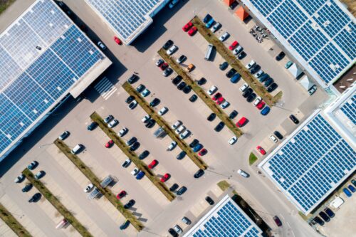 aerial view of parking lot with solar roofs