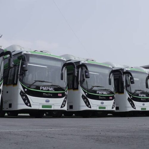 electric buses lined up at a bus depot