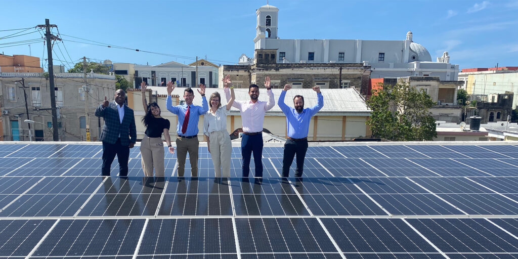 CERI team standing by rooftop solar panels