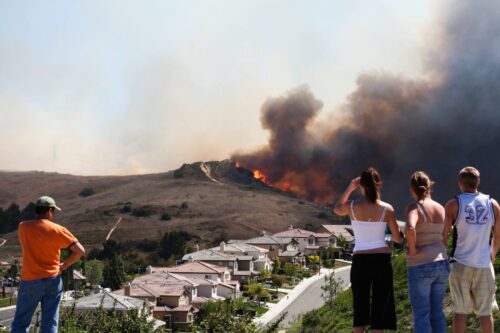 Fire threatening homes with onlookers