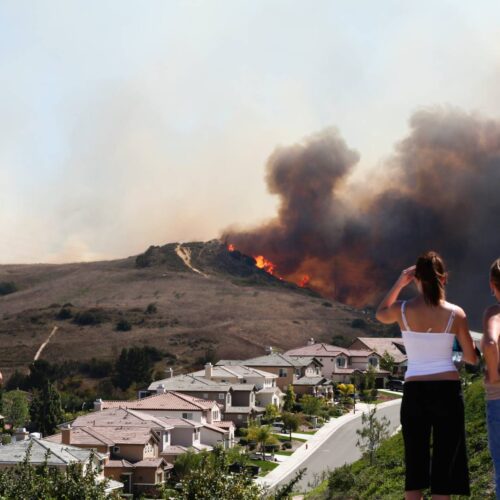 Fire threatening homes with onlookers