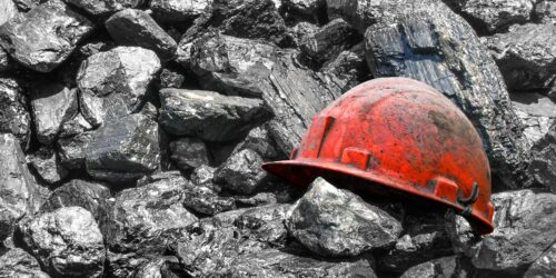 coal pile with worker's helmet