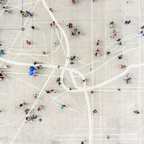 aerial of people walking along sidewalk gridlines