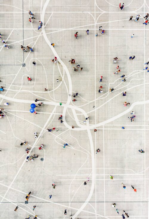 aerial of people walking along sidewalk gridlines