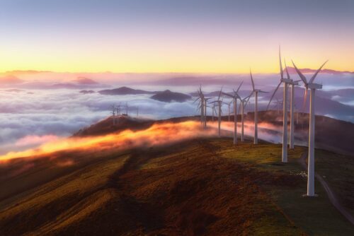 mountaintop wind turbines with clouds