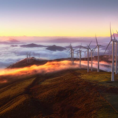 mountaintop wind turbines with clouds