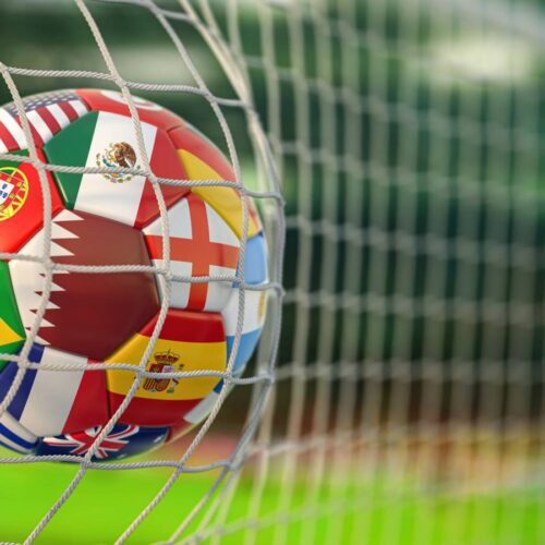 world flags on soccer ball in goal