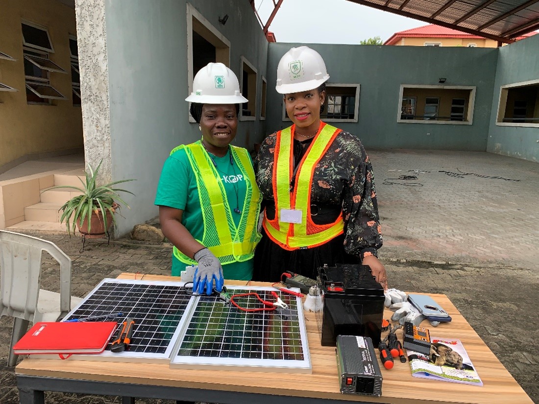 Photo Caption: Glory Oguegbu (right) and RETTI student Omolara Mustapha, a beneficiary of the RETTI scholarship scheme during a solar panel installation practical. 