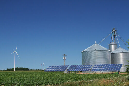 windmill and solar panels on a farm