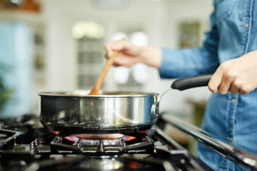 woman cooking on gas stove