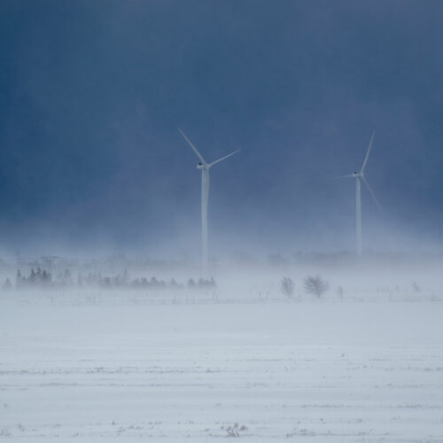 winter storm covering wind turbines