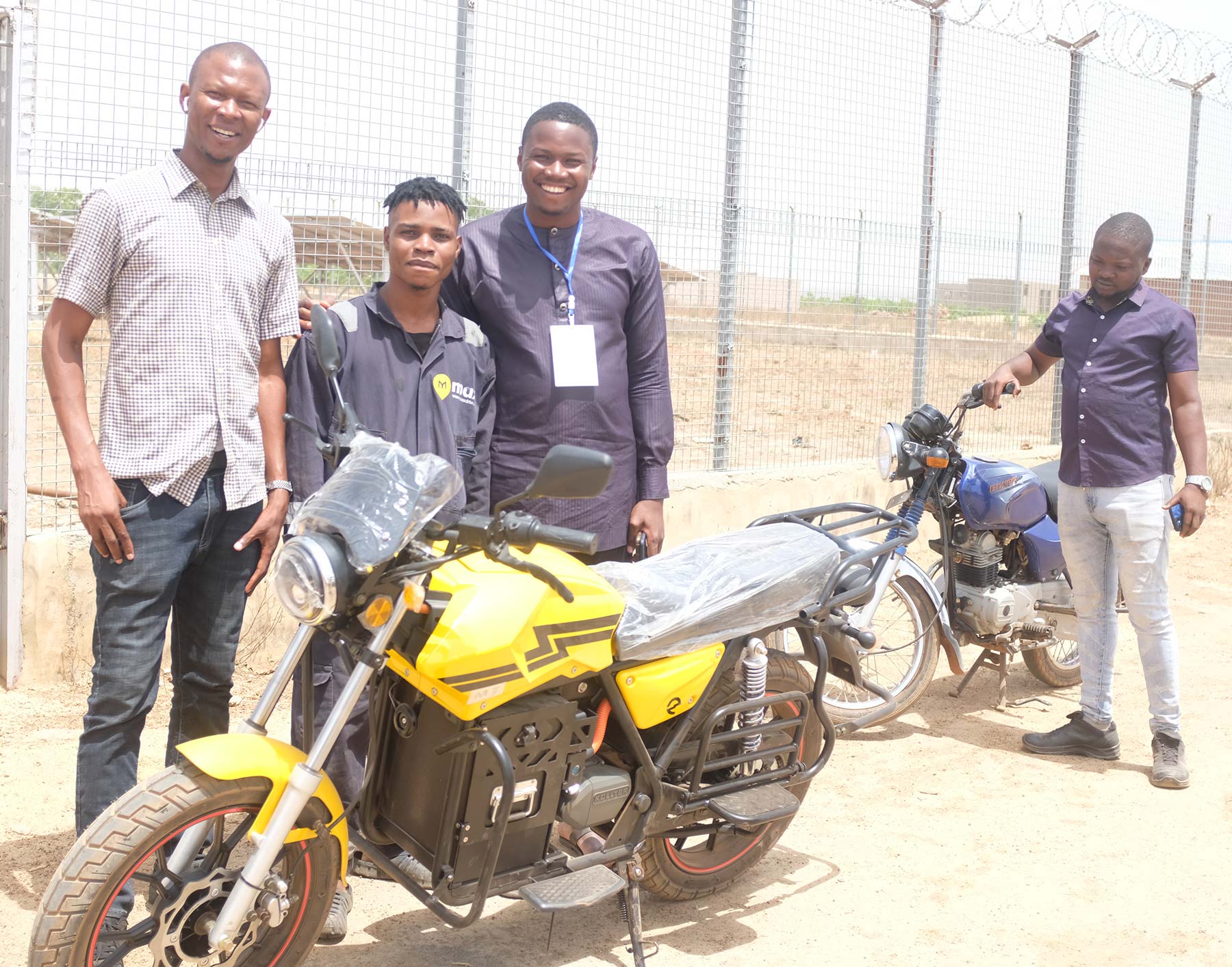 Deji Ojo, Associate with the Africa Energy Program with One Acre Fund and Baban Gona at a training workshop testing electric bikes for farm logistics