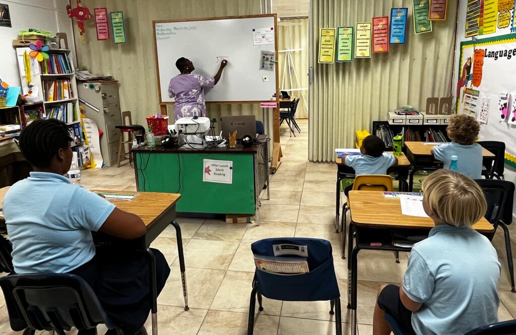 Mrs. Clarke, principal of Mar-O-War Primary School, teaches students mathematics. Photo credit RMI.
