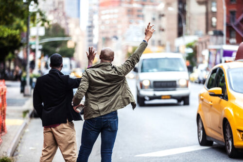 two men hailing a taxi