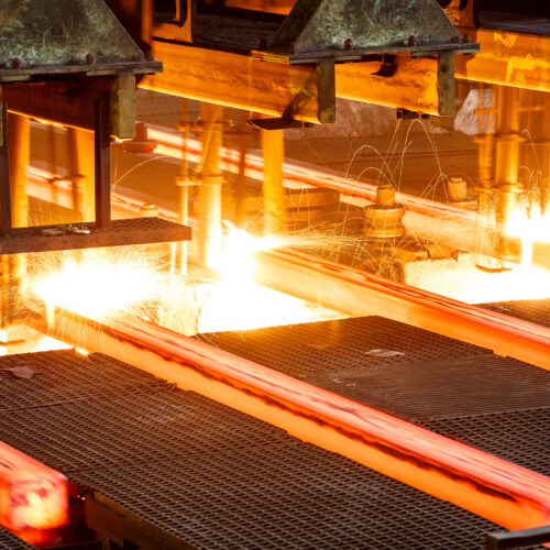 hot steel on conveyor Close shot in steel mill