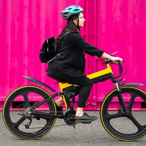 woman riding bike with pink background