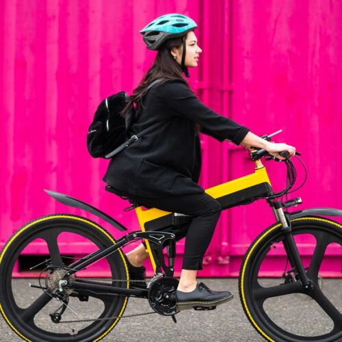 woman riding bike with pink background