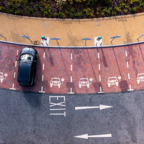 Overhead view of car parked at charging station