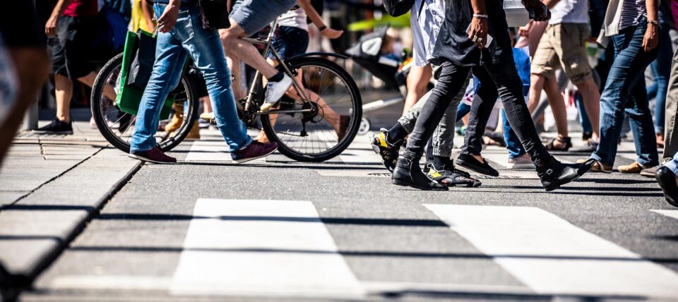 crosswalk with people walking and biking