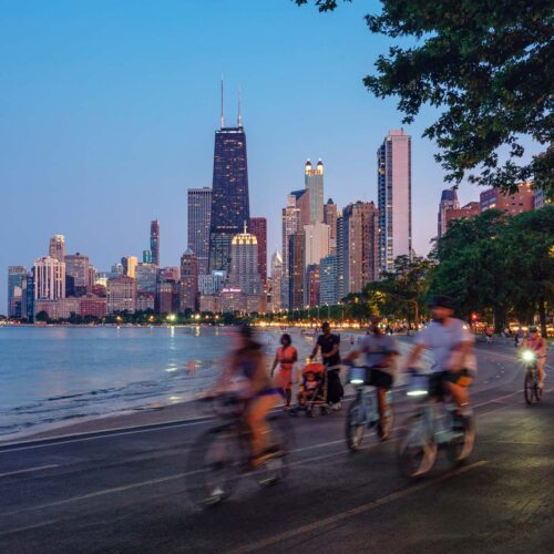 people biking with Chicago skyline in background