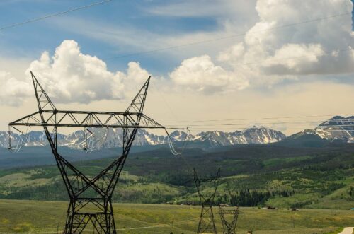 powerlines in front of a mountain range