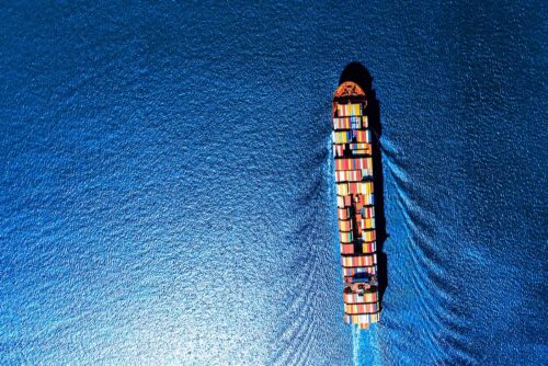 cargo ship on open ocean aerial view