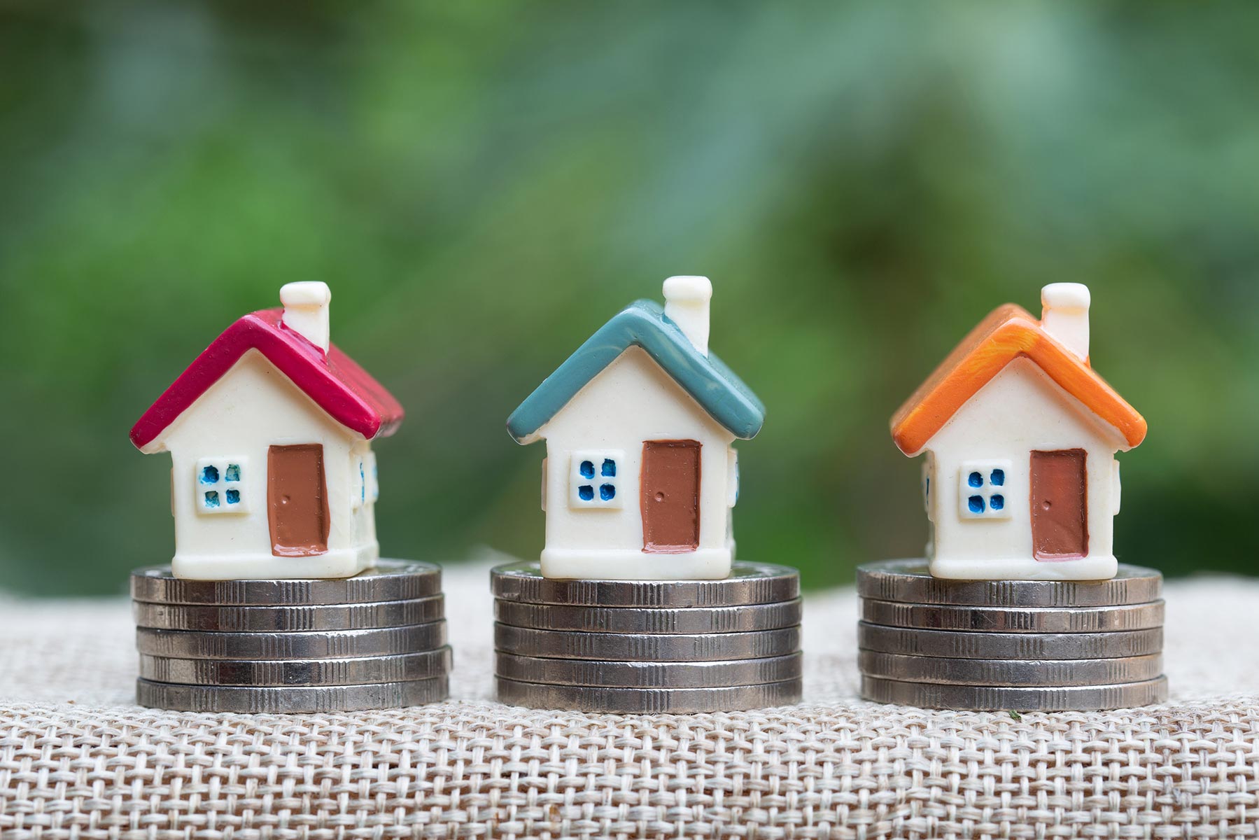 mini houses stacked atop coins