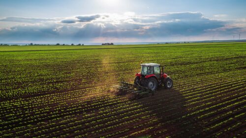 farm tractor harvesting a field