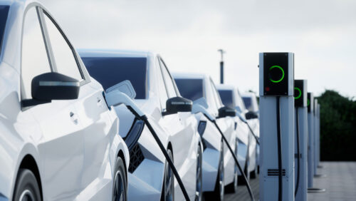 line of electric cars charging